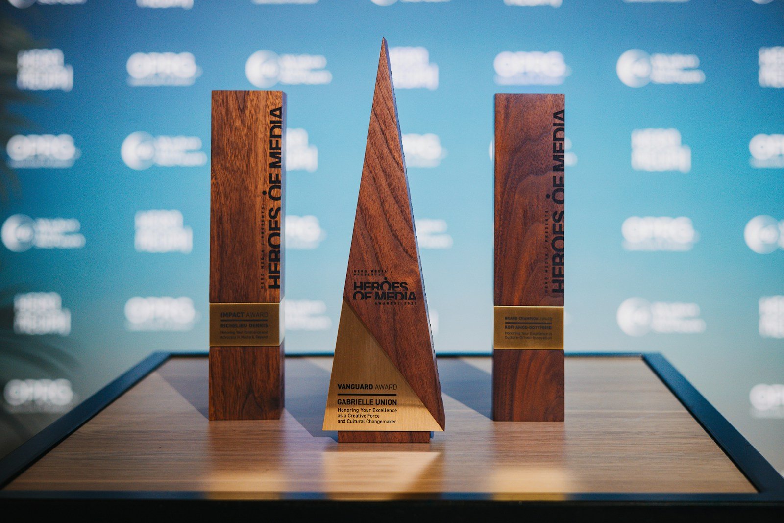 Three wooden awards on a table